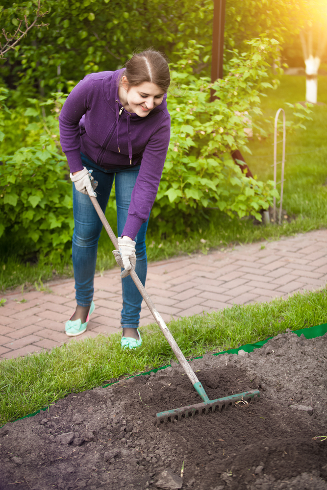 young woman preparing soil for a tea garden